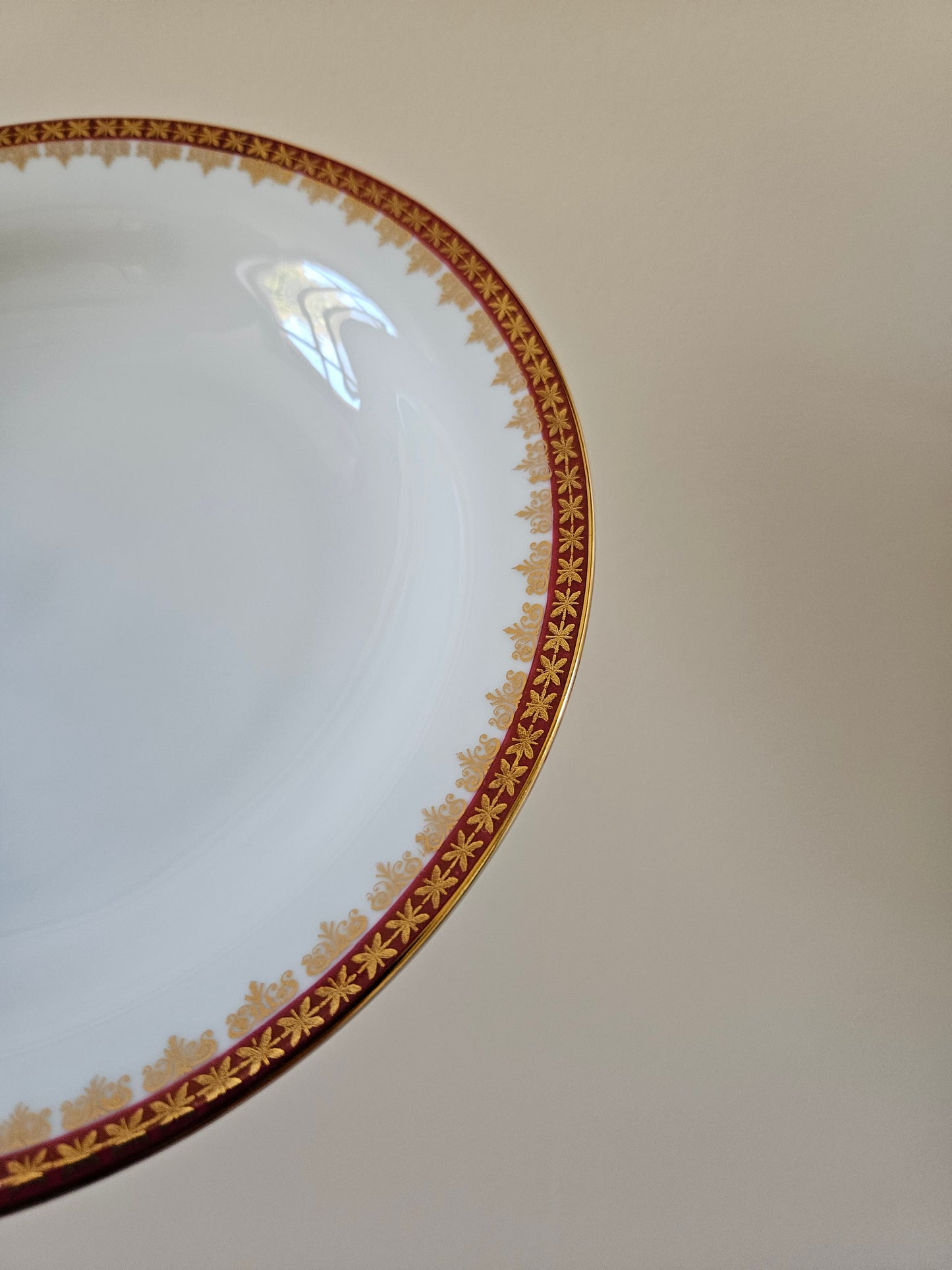 Décor rouge et doré sur assiette vintage en porcelaine. 