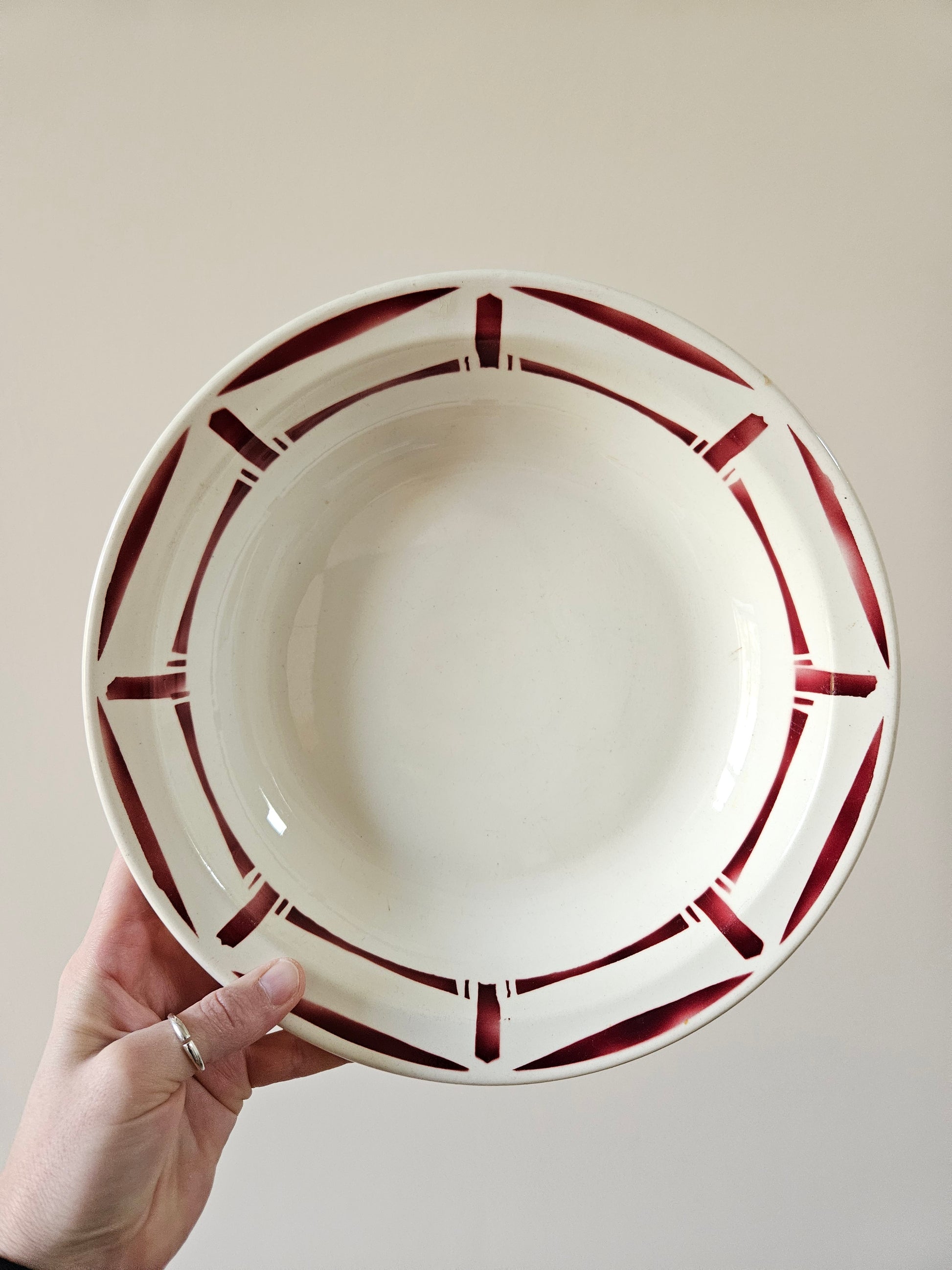 Plat creux vintage manufacture Badonviller. Modèle Louise. Décor géométrique rouge bordeaux.